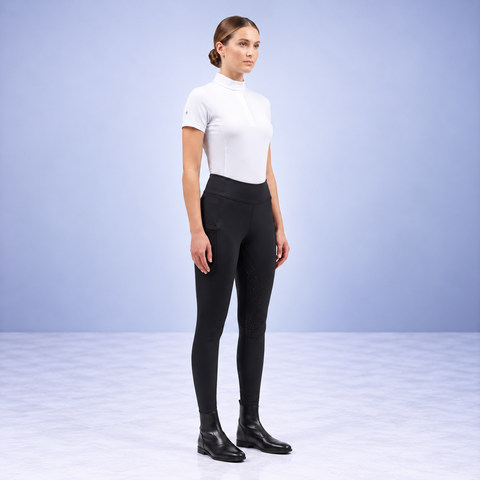 Black riding tights with high waistband worn with a white top and short boots